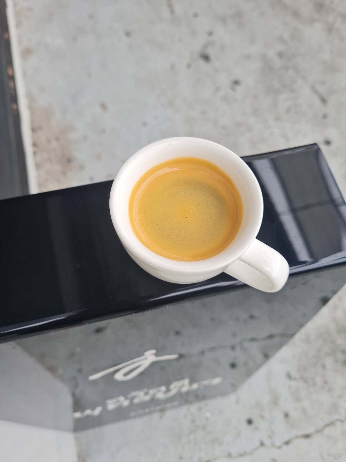 Fresh espresso with golden crema in a white demitasse